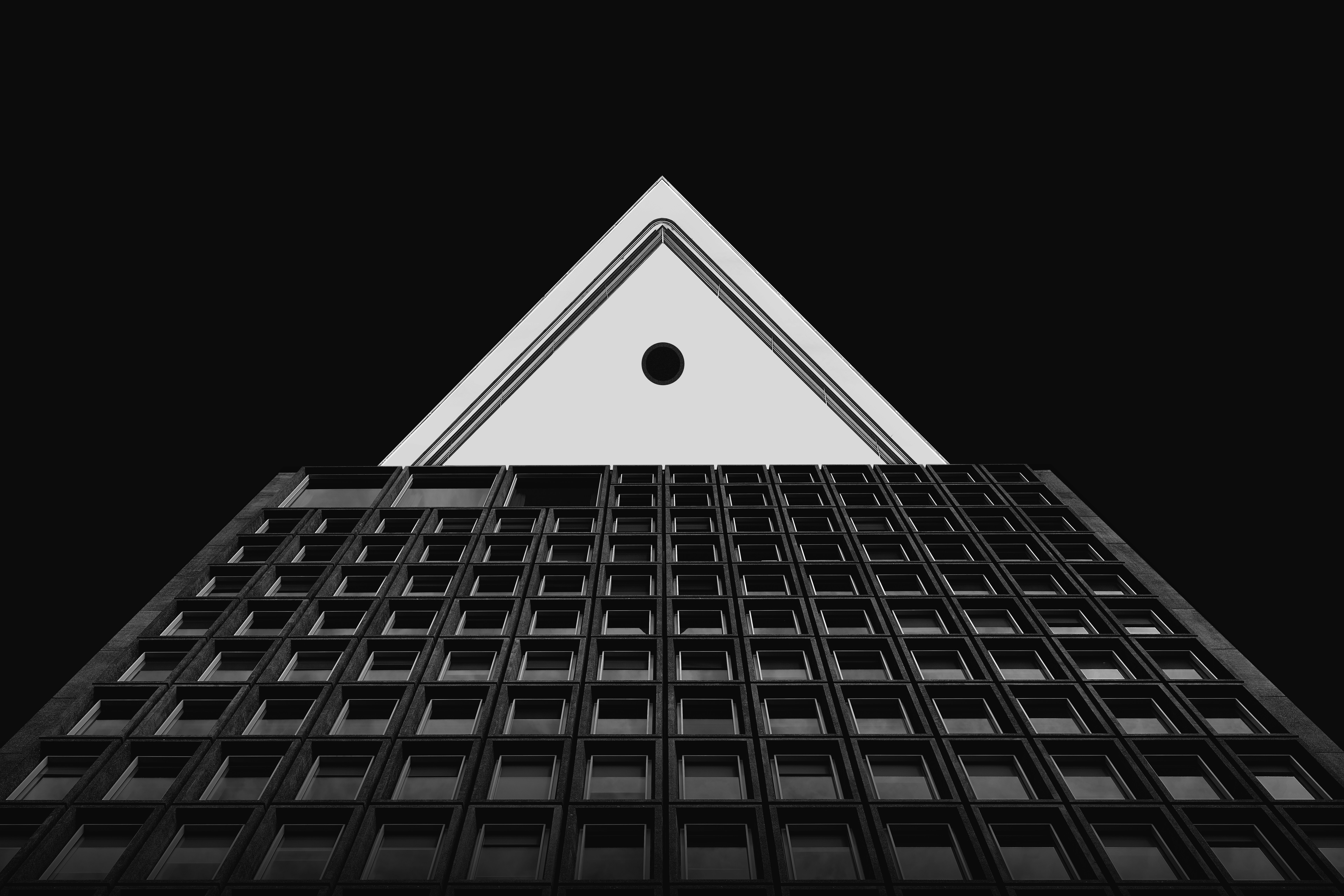 Triangular structure above a grid of windows