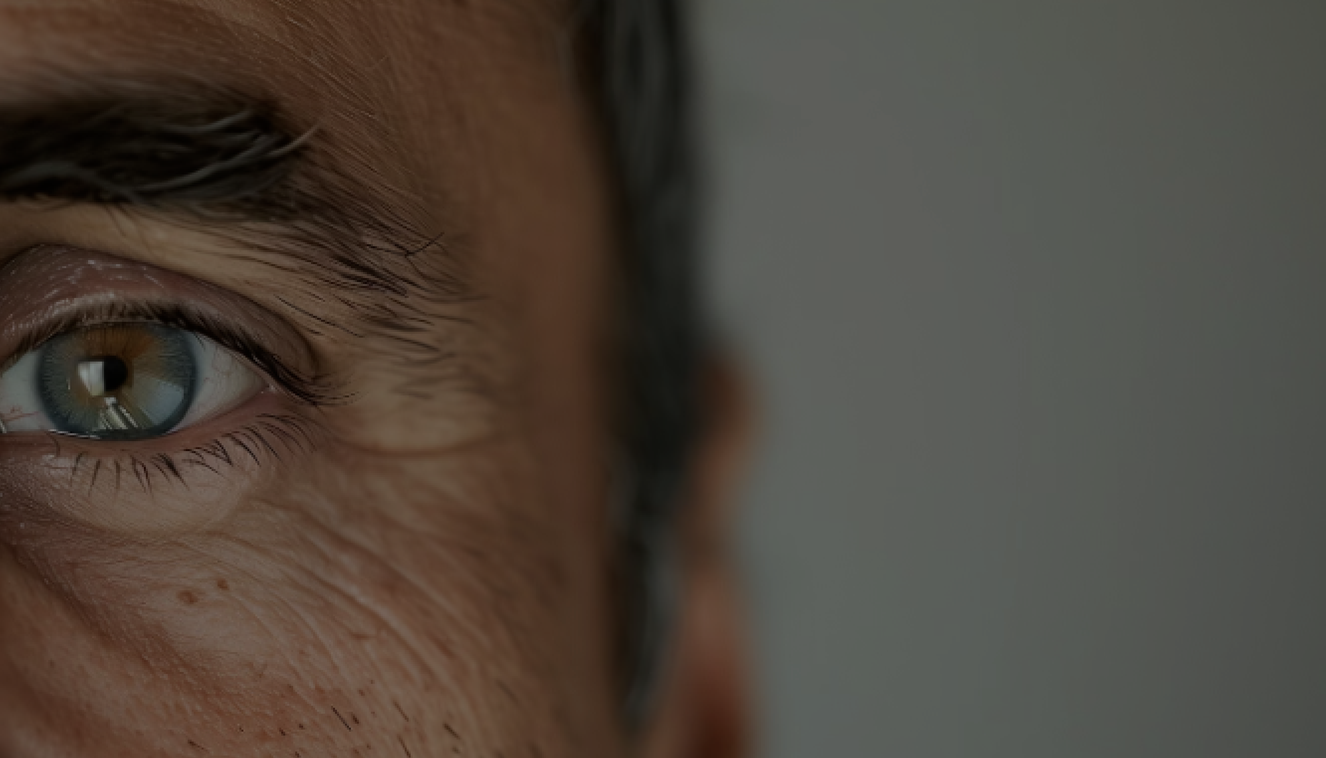 Close-up of an eye with creative makeup and white feathers.