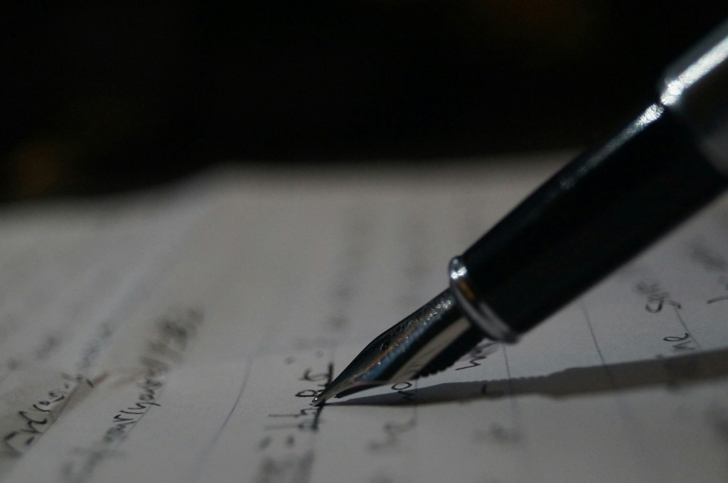 a pen is sitting on top of a piece of paper