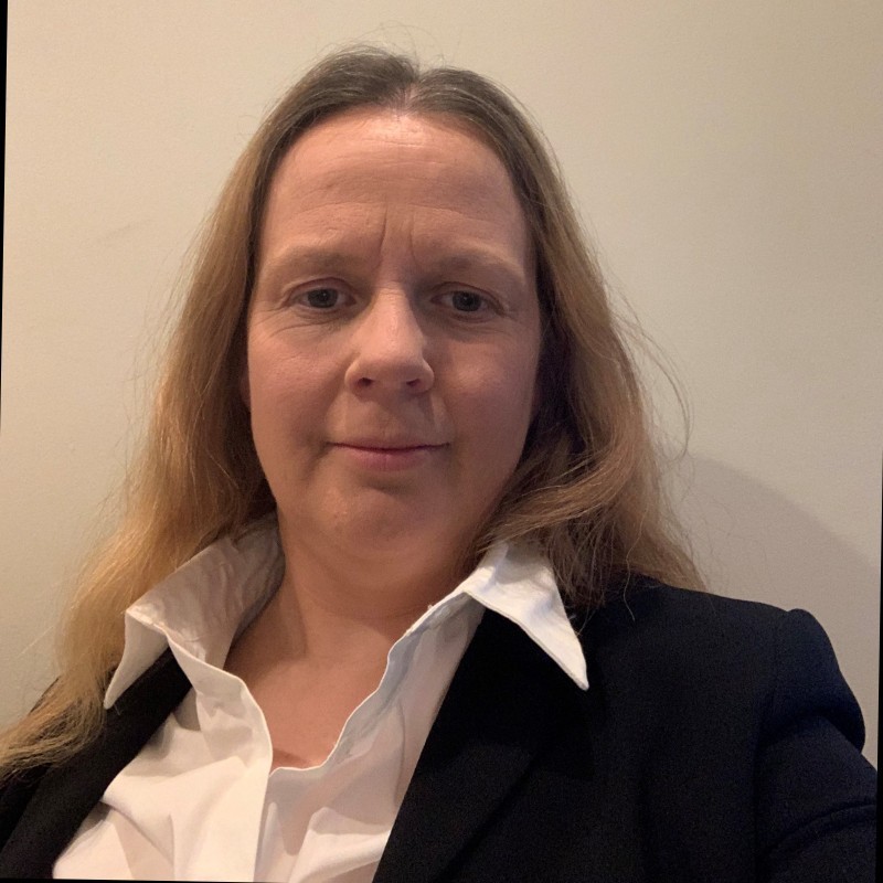 a man in a blue suit posing for a picture