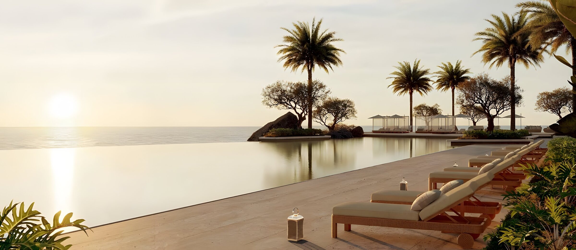 Infinity pool at sunset with ocean views, a key highlight of this exclusive real estate opportunity.