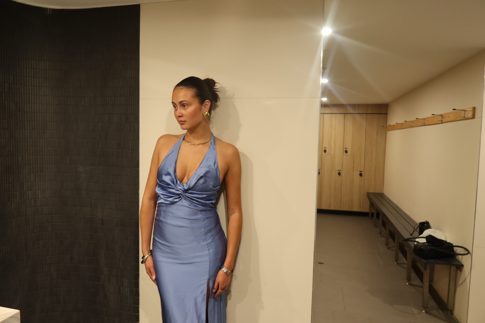 Blue satin halter-neck gown with ruched bust detail, fitted waist, fluid skirt, and thigh-high front slit