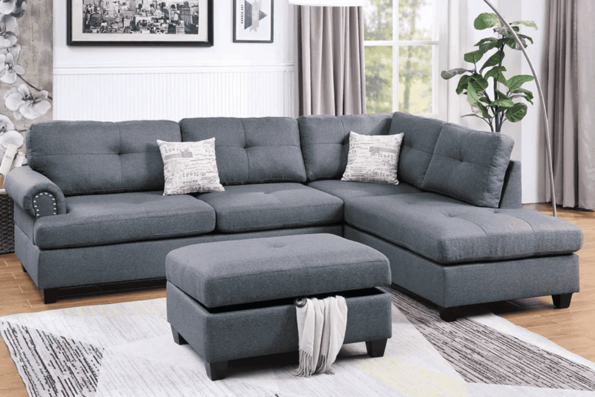 Gray Poundex black sectional sofa with accent pillows in a modern living room with wooden floors and framed art