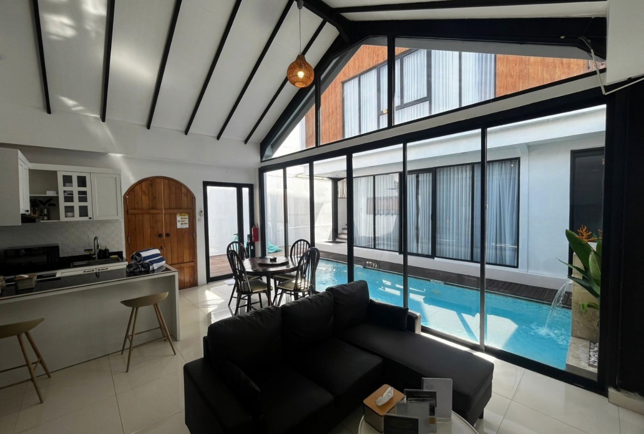 Open-plan living room with pool views. Expert real estate services for luxury villas at Nyanyi Beach.