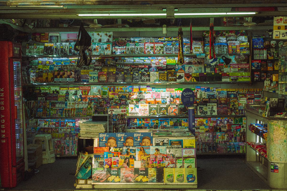 A rack of printed magazines and brochures representing static print and PDF prospectuses