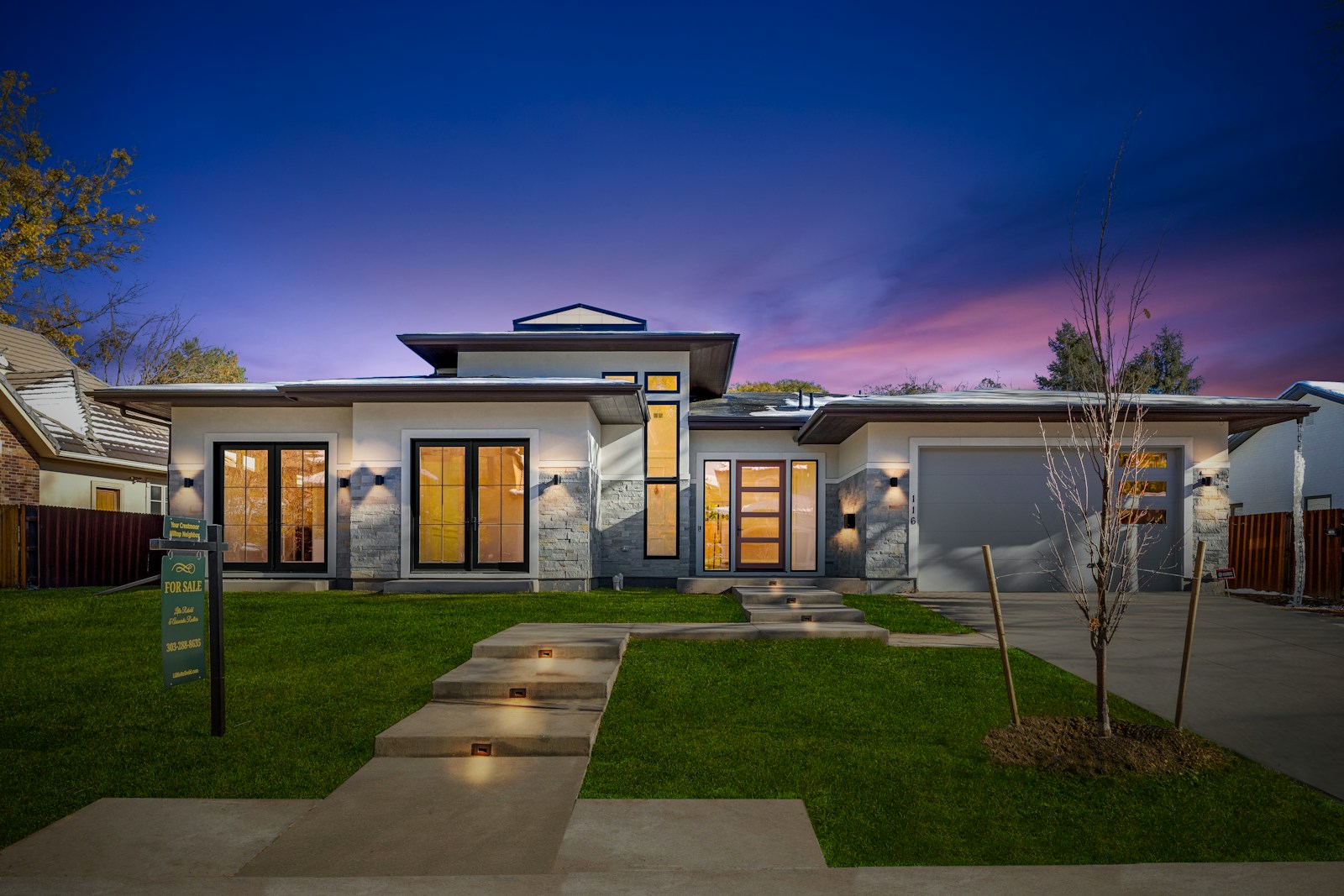 Contemporary custom home exterior at dusk