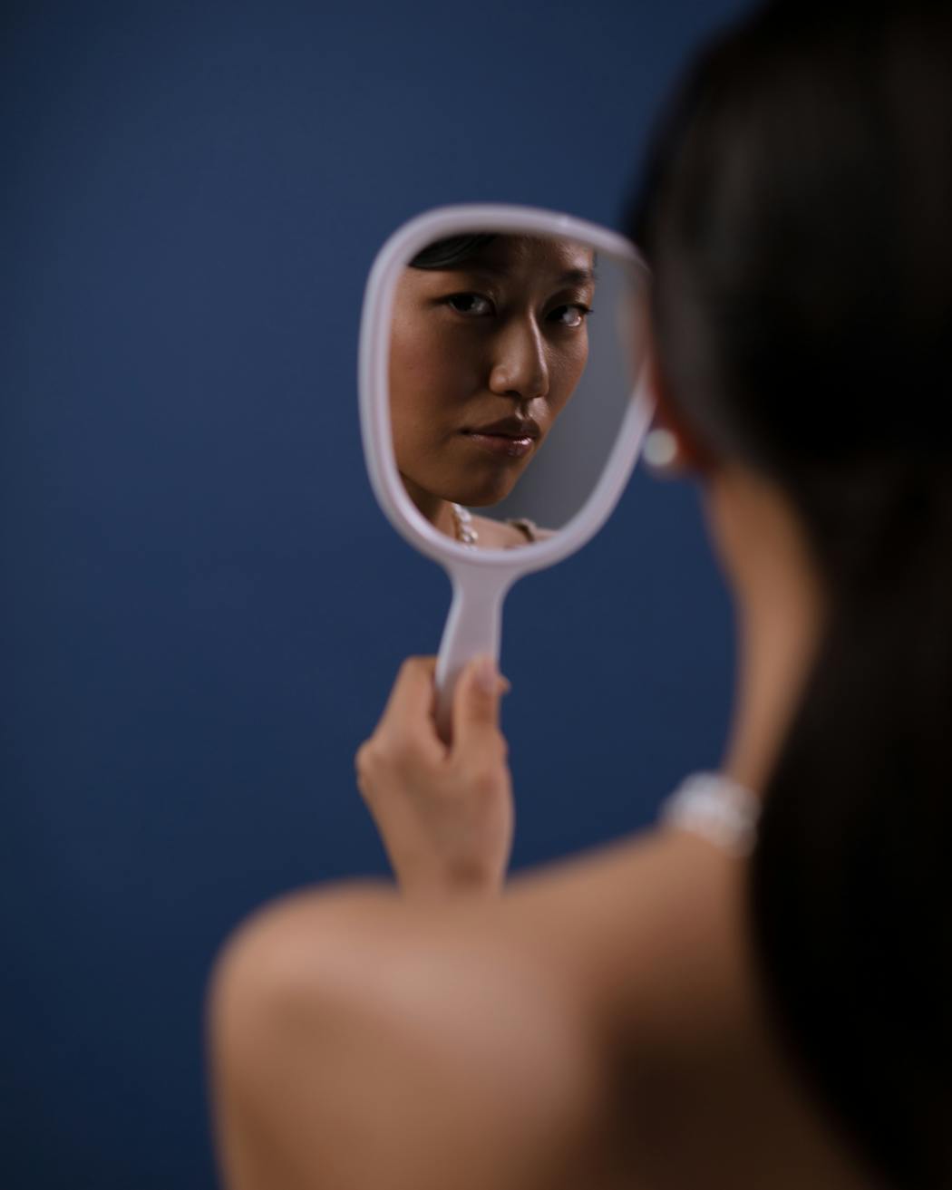 A woman looking at a mirror