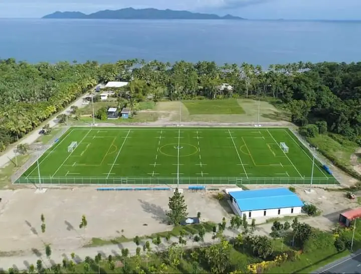 Aeriel view of a sports field alongside the beachside oceanview in fiji