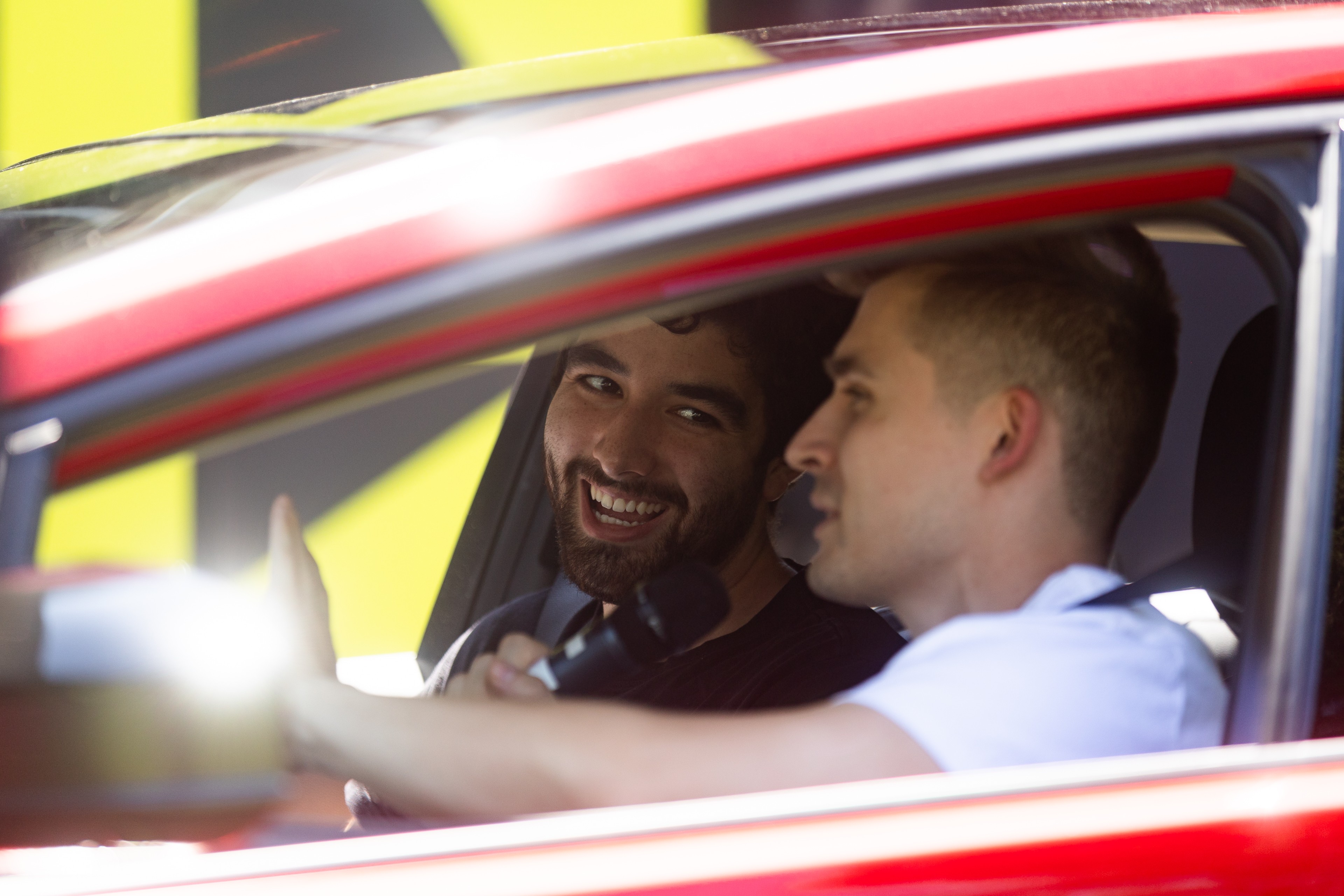 Ludwig Ahgren and a guest laugh inside the Prius during an in-car segment
