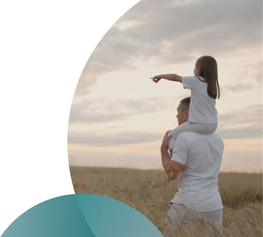 Couple cooking together in a bright kitchen while smiling at each other.