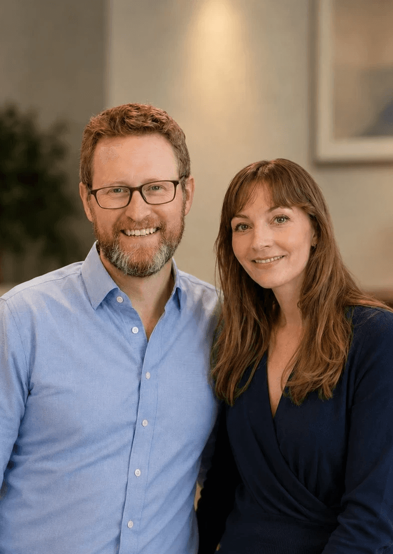 A man in glasses and blue shirt and a woman in a blue sweater