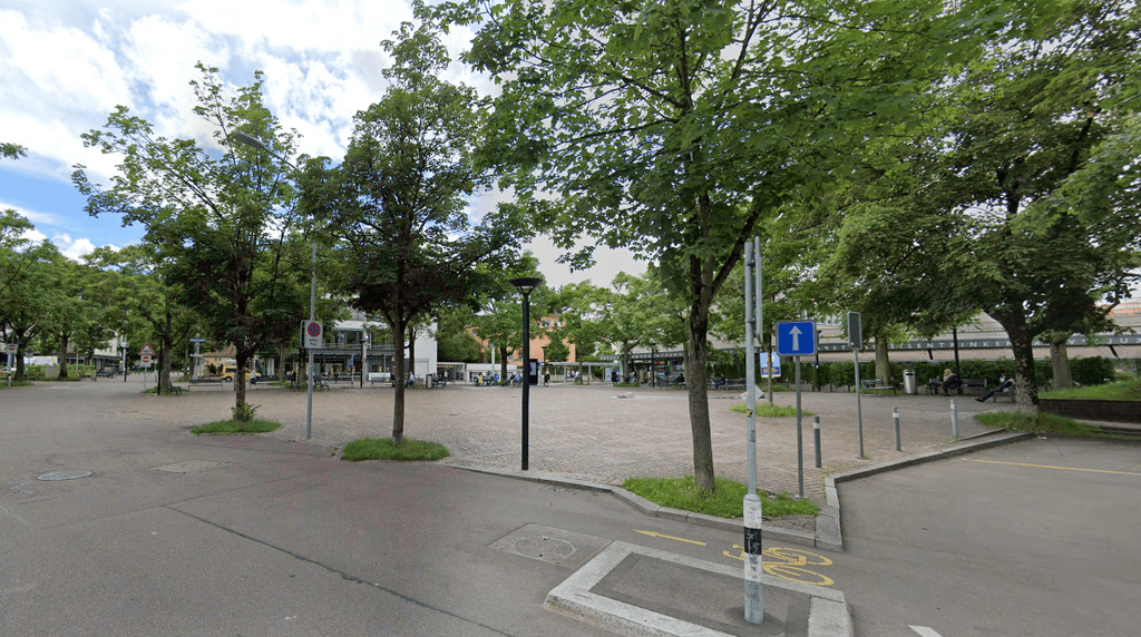 An empty road with a hospital in the background.