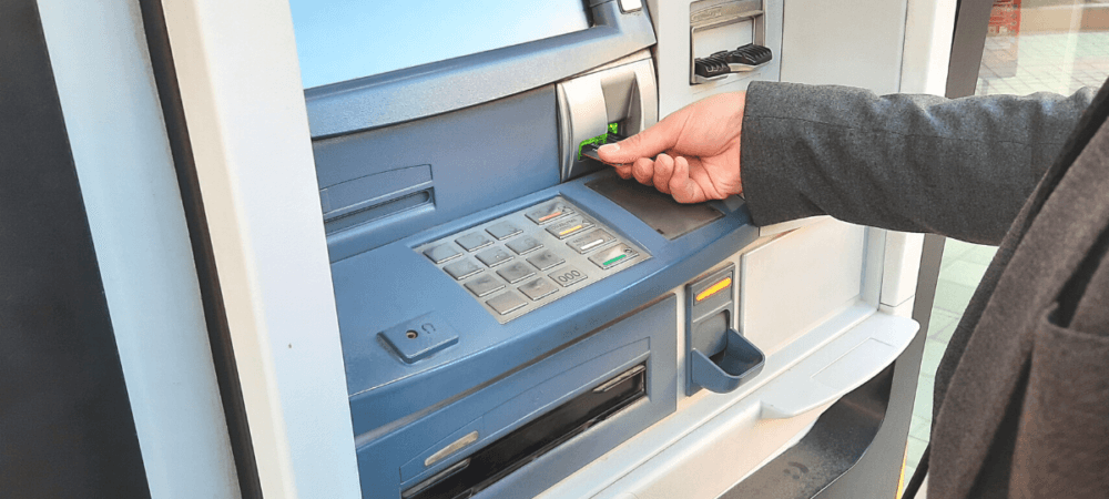 Person trying to get money out of ATM