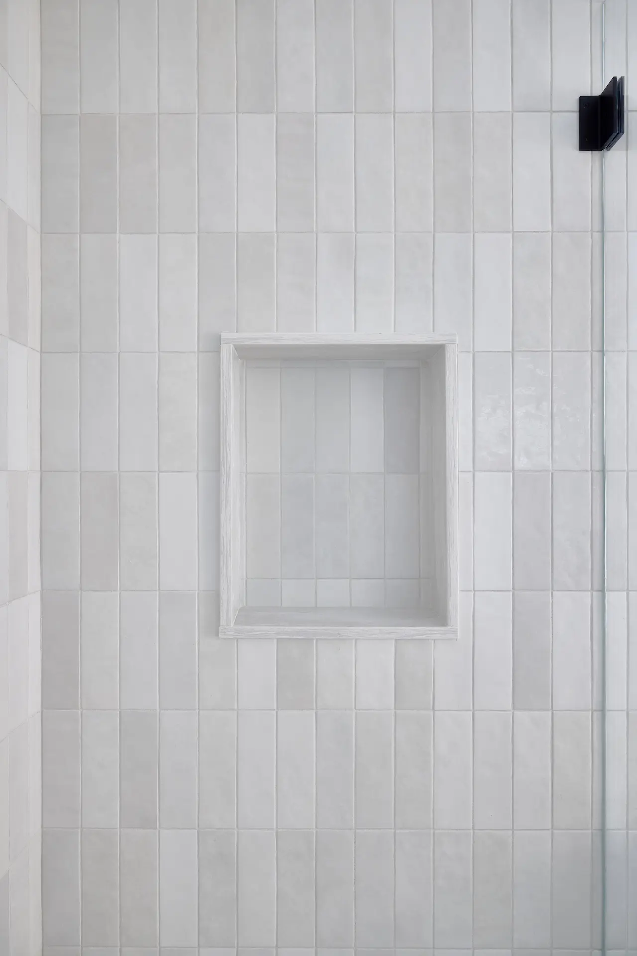 Portrait of the shower niche in ADU Orange, set against subway tile walls, marrying modern functionality with classic aesthetics. Photo by Todd Huge.