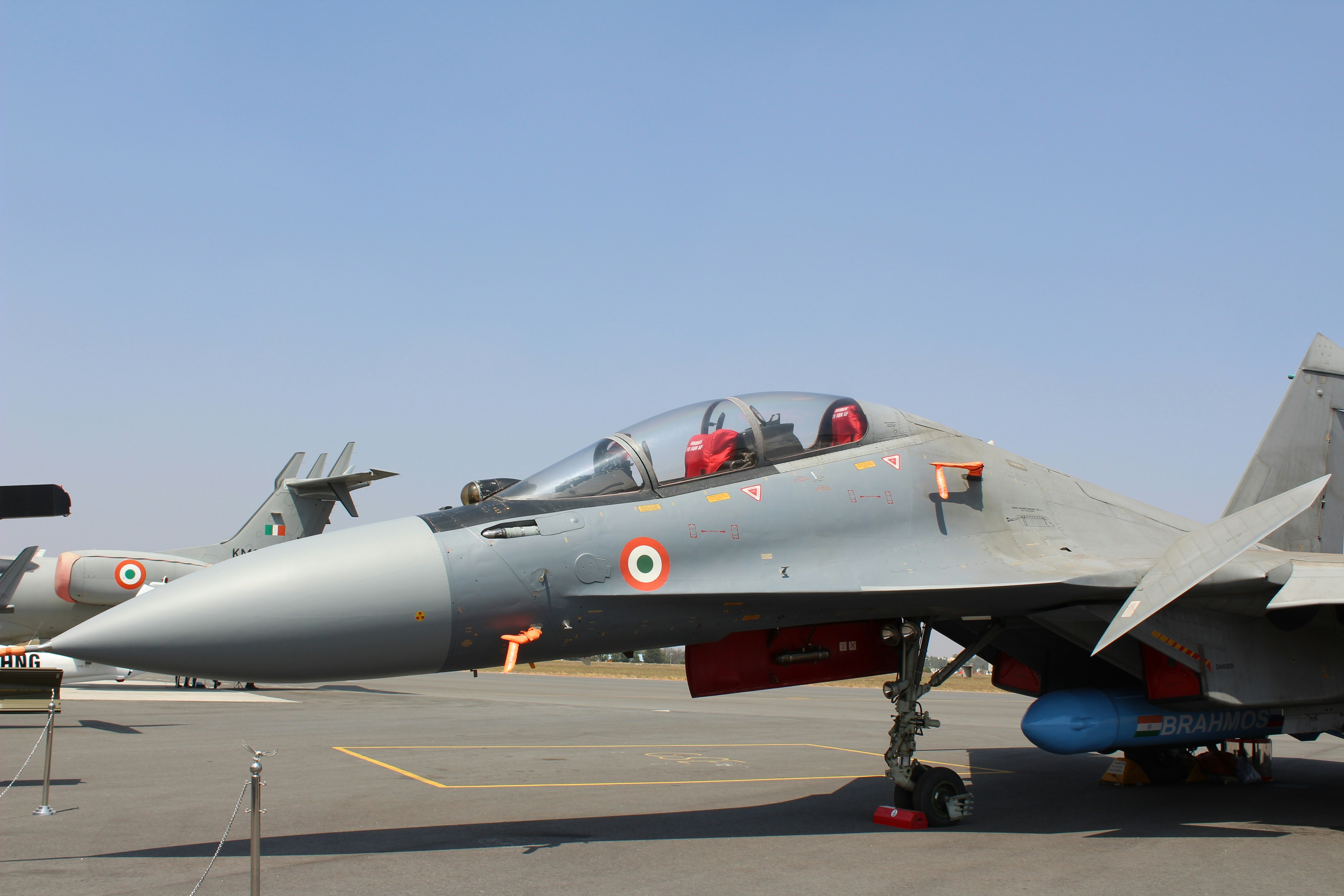 A fighter jet sitting on top of an airport tarmac