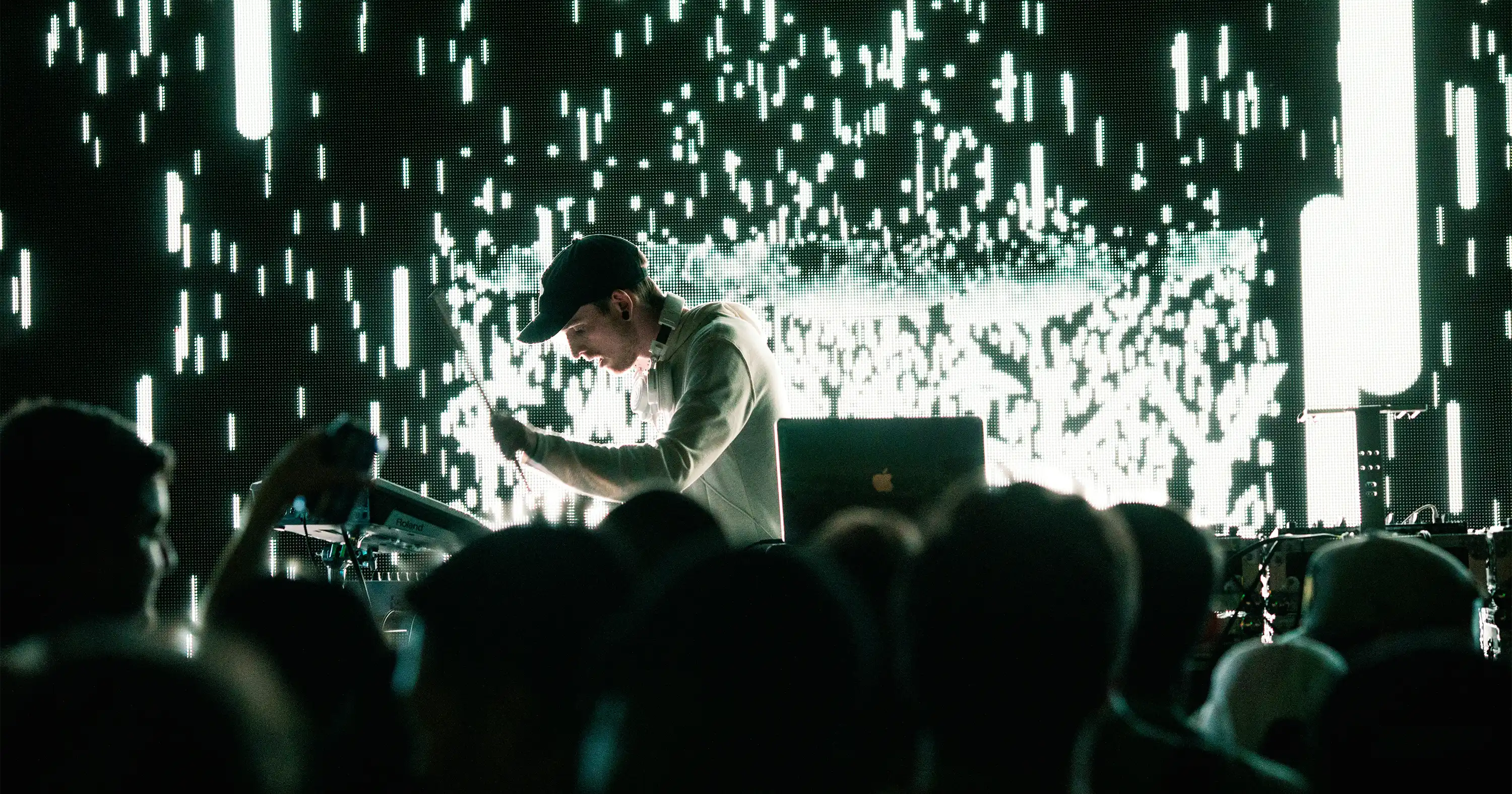 a dj in a live show with sparks flying in the background