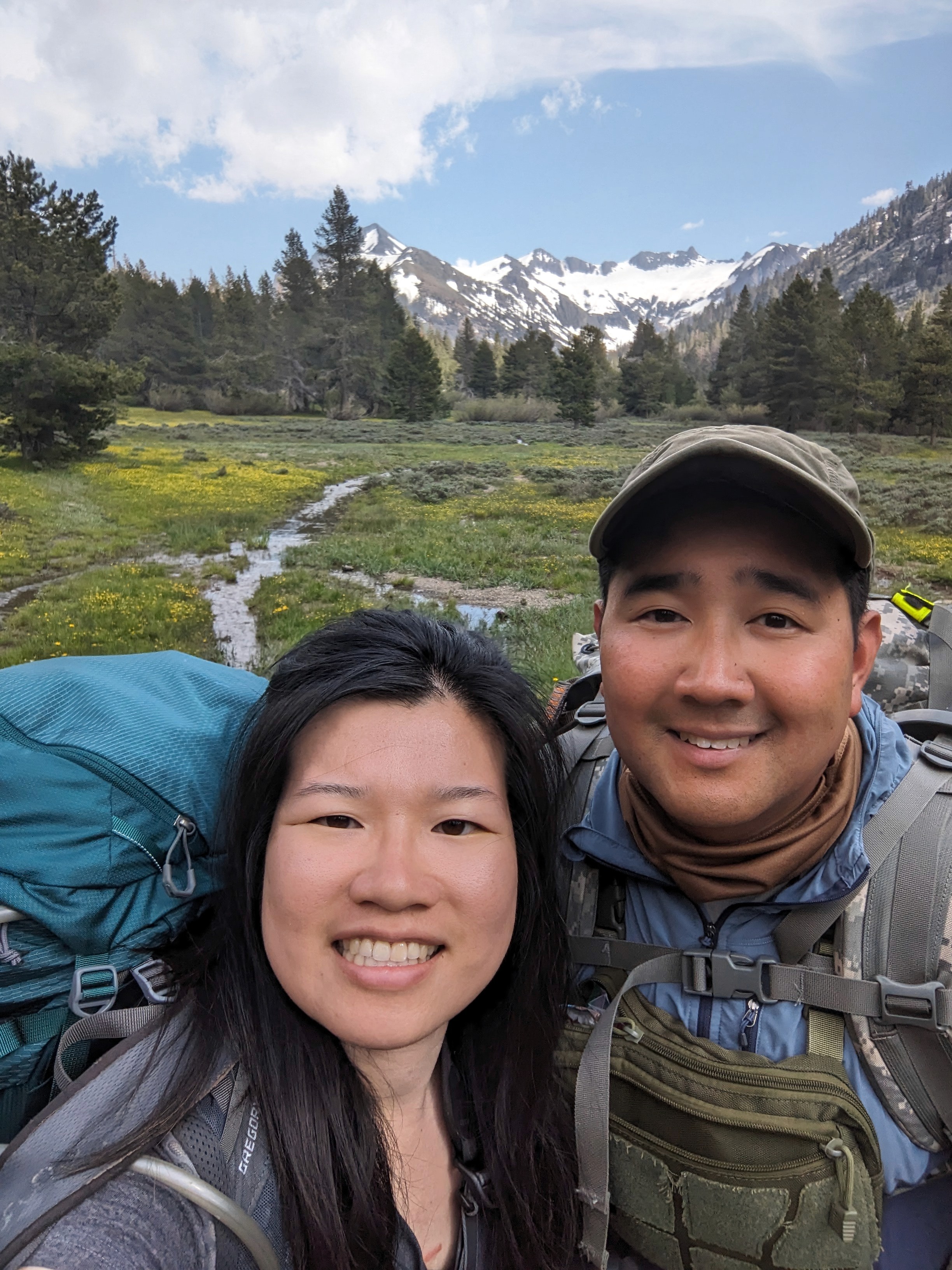 A close-up of two people holding hands, one wearing a denim jacket. The background is softly blurred, suggesting a tender, intimate moment in warm light.