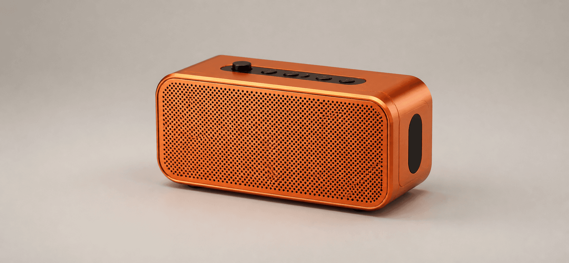 Portable smart speaker in orange anodized aluminum