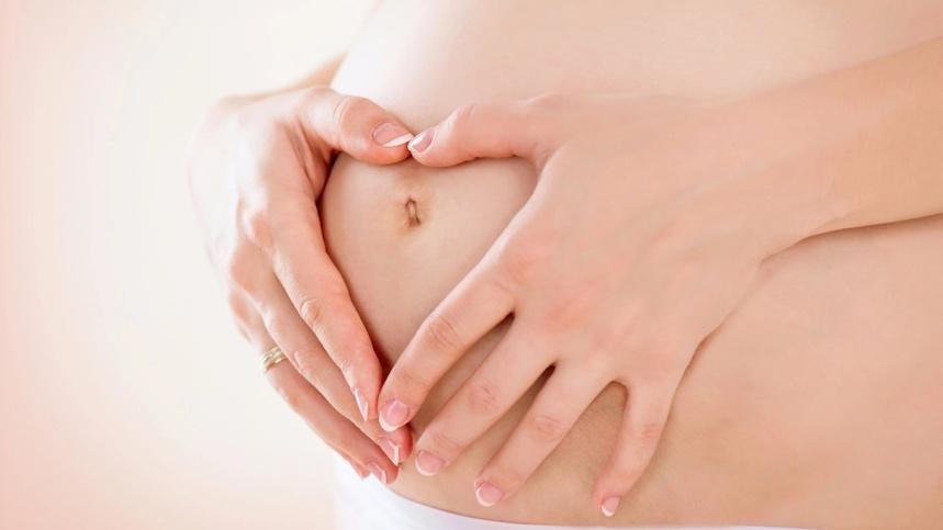 A pregnant person holding her hands on her stomach

AI-generated content may be incorrect.
