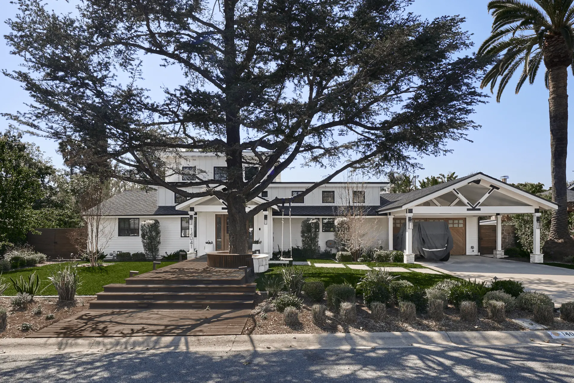 North Tustin Remodel & Addition featuring grand front yard with iconic tree and portico. Photo by Todd Huge.
