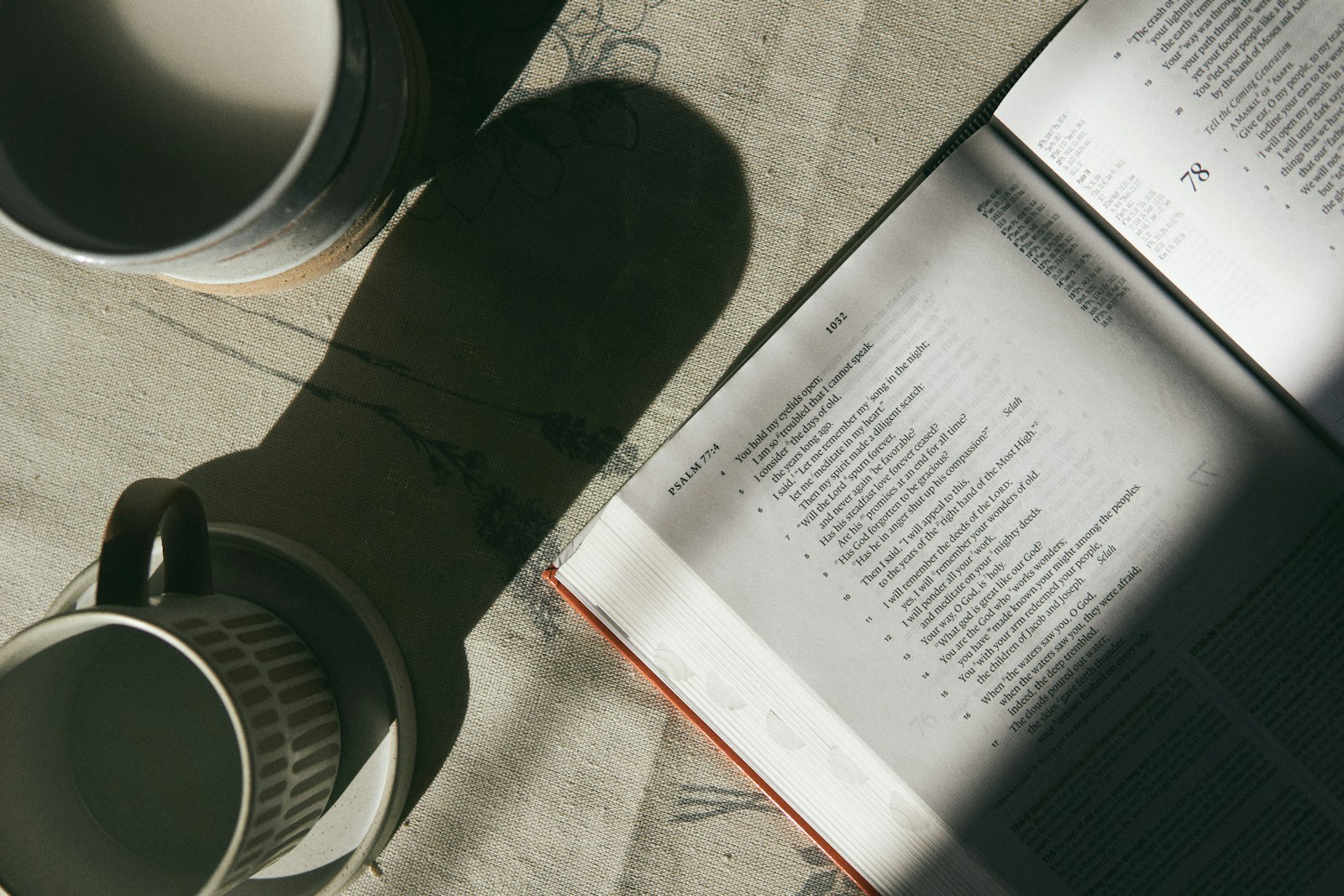 Coffee mug beside an open book