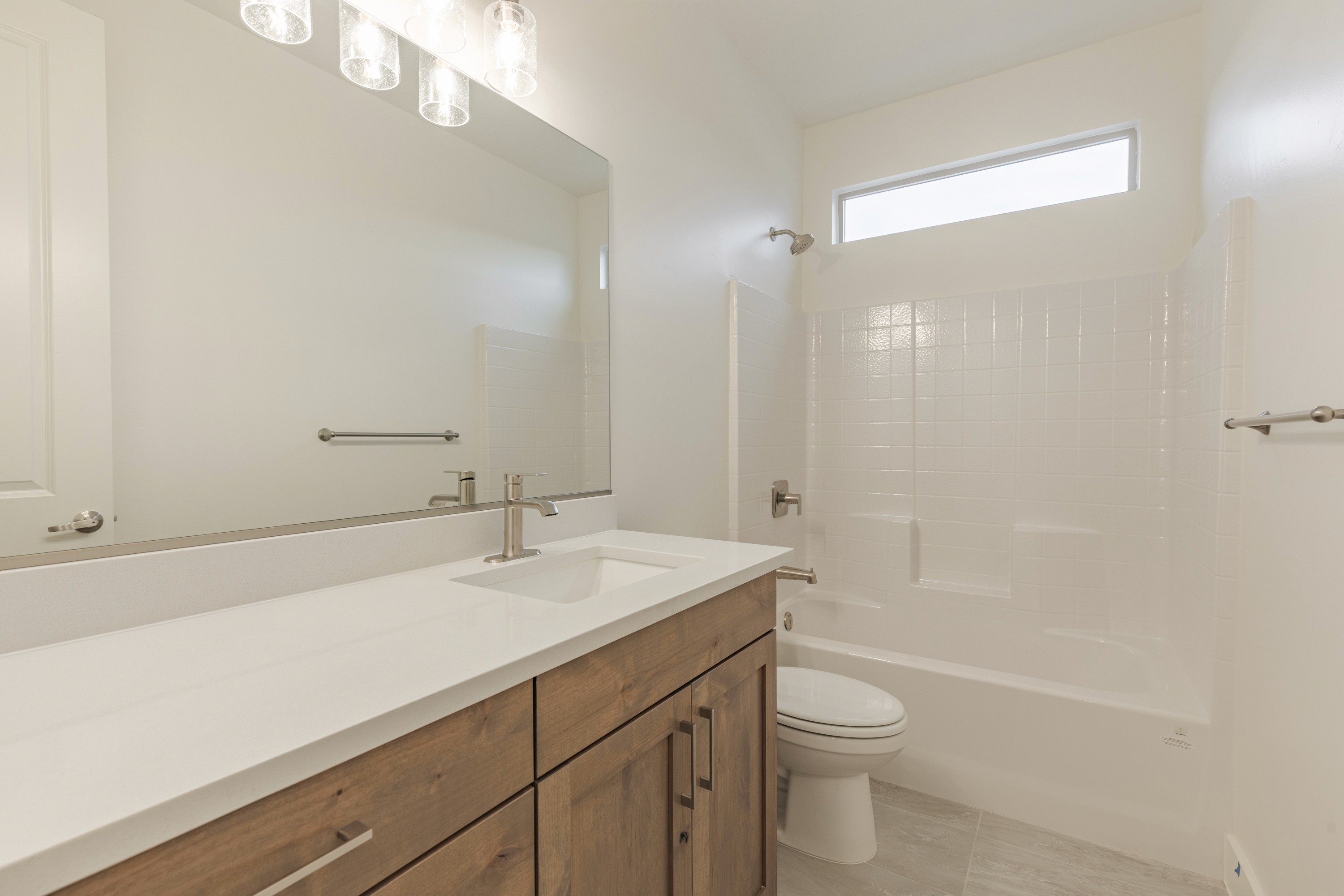 Secondary bathroom in the Painted Sands twin home in Hurricane, Utah with vanity and tub combination.