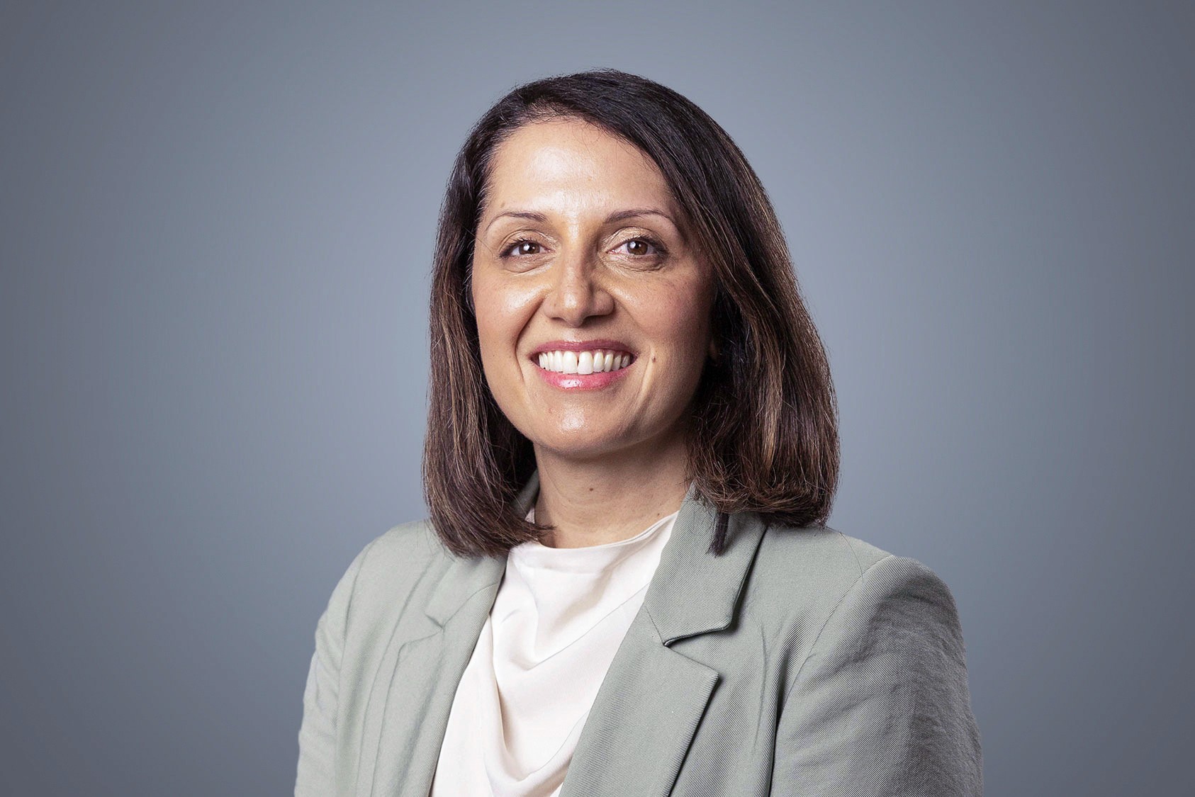 Sima Acharya, SteriMax Chief of Staff: Smiling in professional business attire against a neutral studio background.
