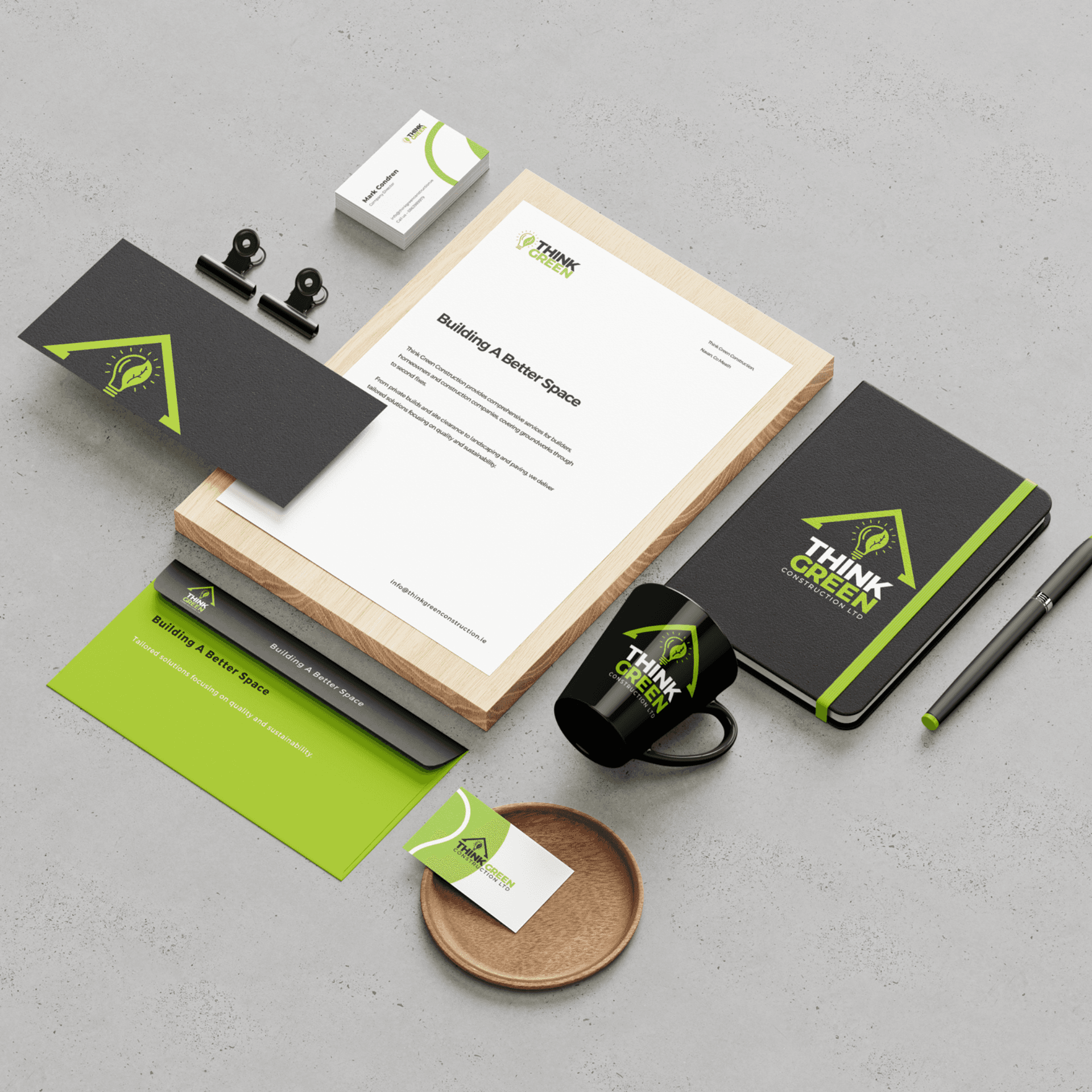 Branded stationery set with green geometric design.