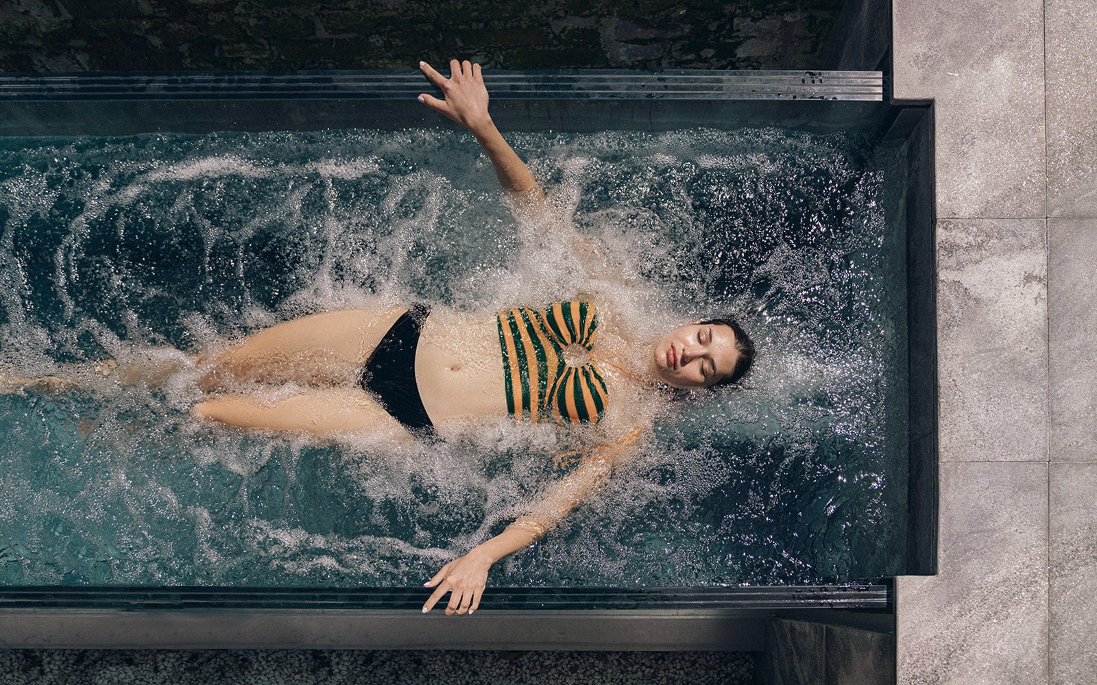 Person relaxing in a spa pool at QC Terme Milano, Italy.