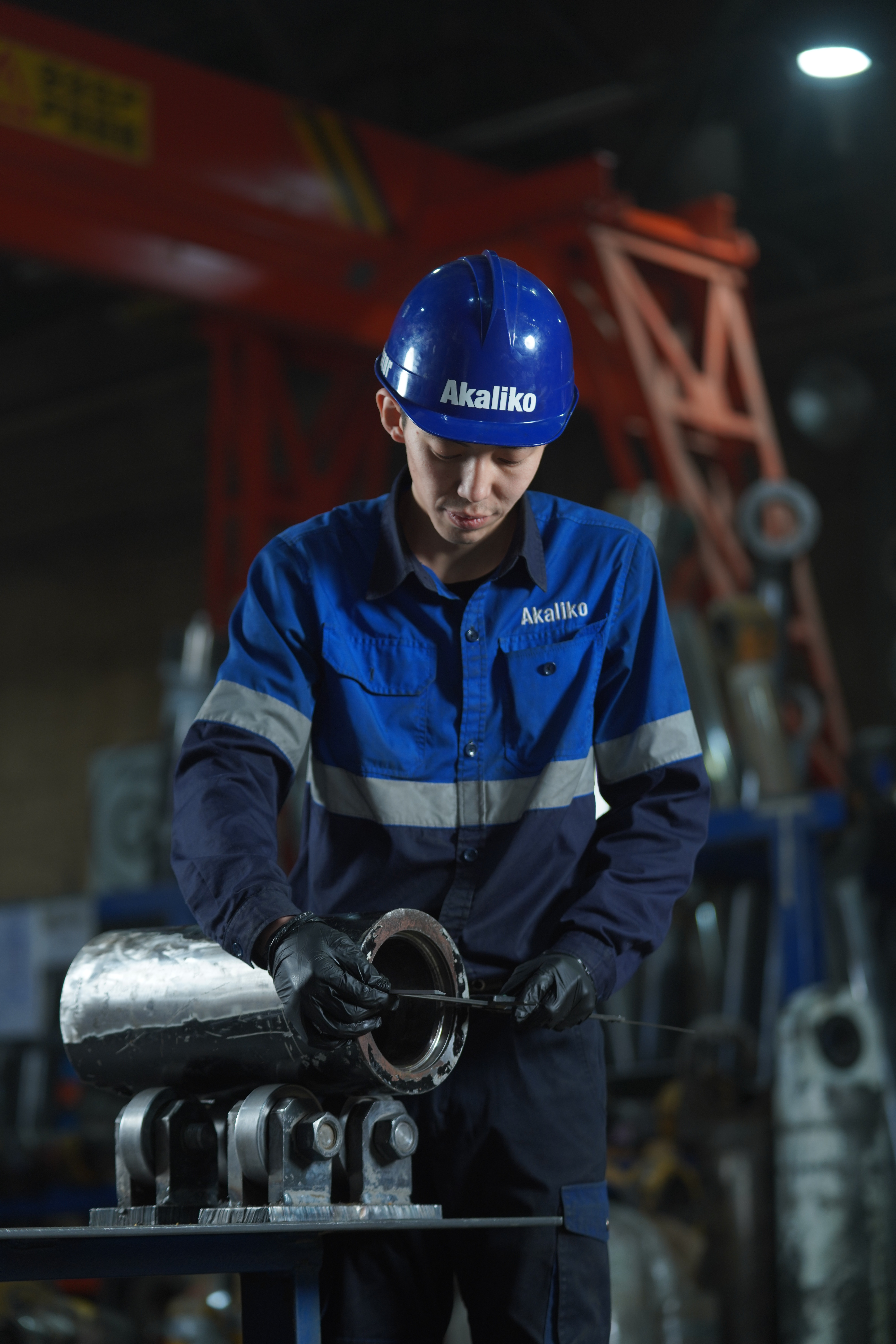 Male engineer in orange uniform and helmet standing with arms crossed          Ask ChatGPT