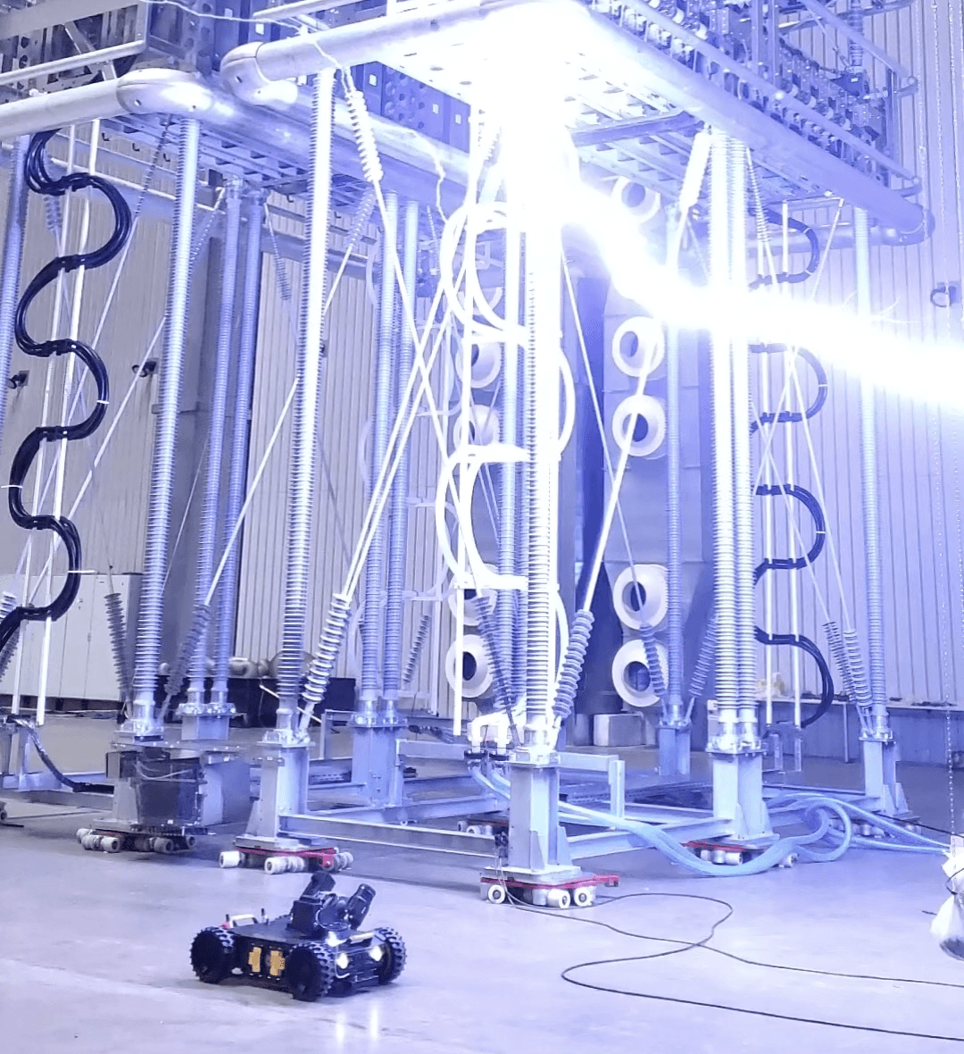 Ross Robotics robot operating beneath energized HVDC equipment in a high-voltage test hall