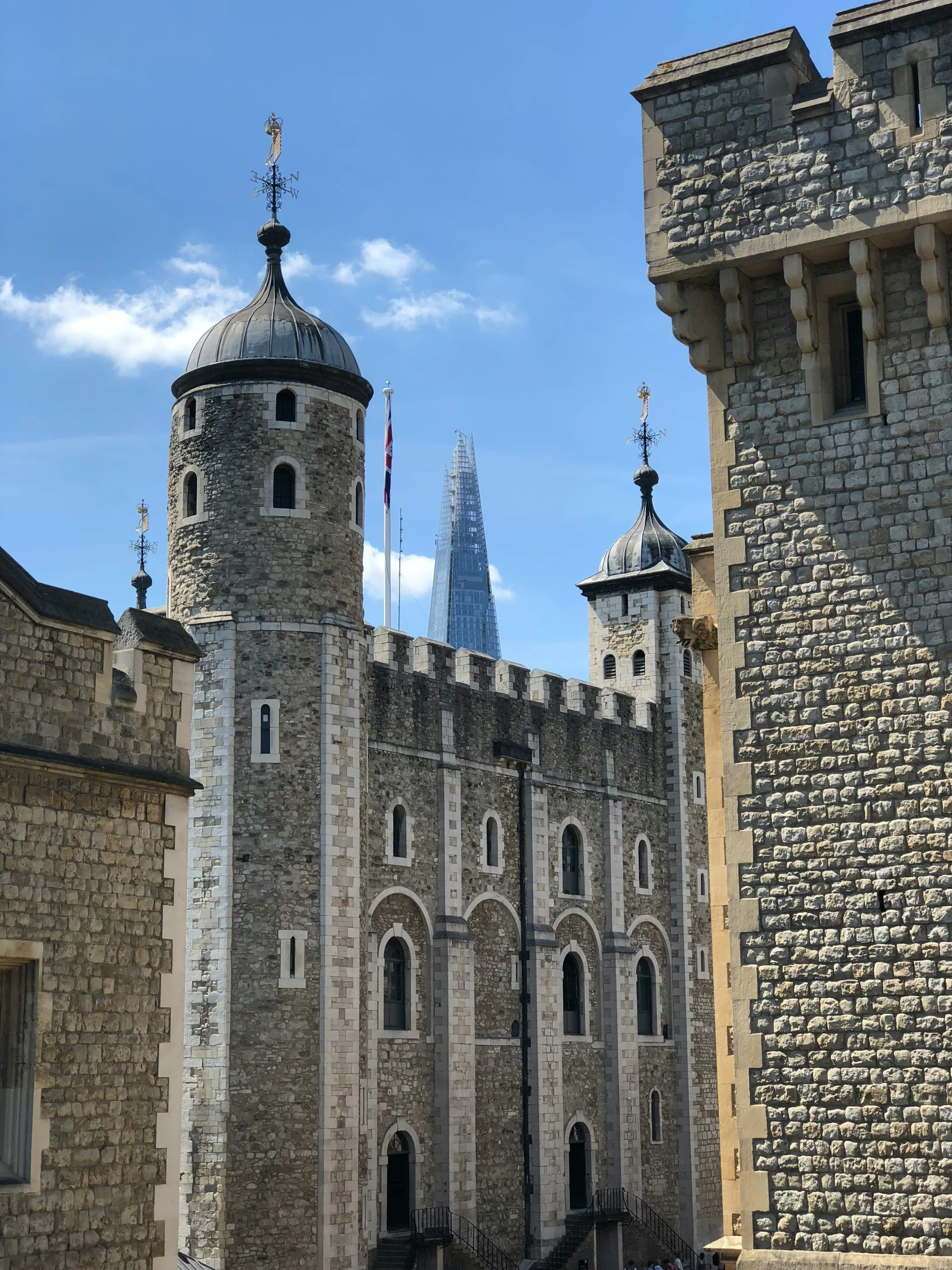 One of the Tower turrets of the Tower of London, with a blue sky behind it.