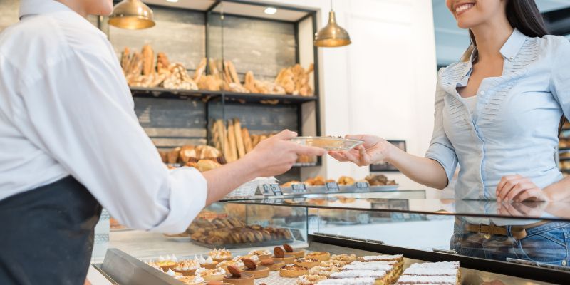 A Malaysian F&B staff talking to a customer