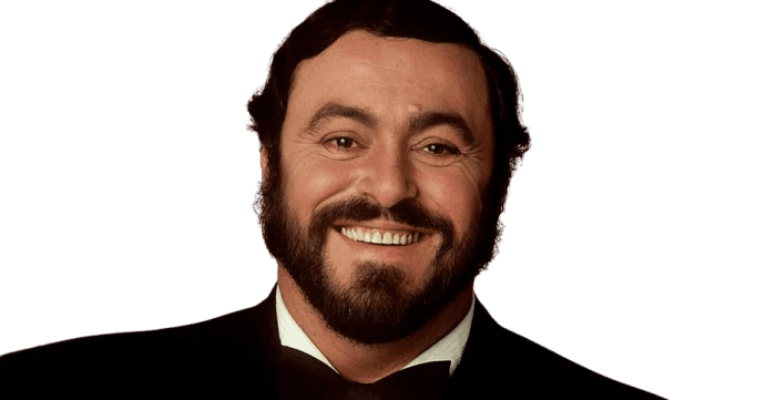 A warm portrait of a bearded man smiling confidently, dressed in a formal black tuxedo with a bow tie. His dark hair and neatly groomed beard complement his expressive eyes, radiating a charismatic and welcoming presence. The soft, neutral background enhances the focus on his joyful expression and elegant attire.