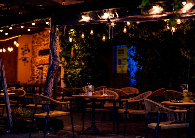 Outdoor dinner gathering with warm lights