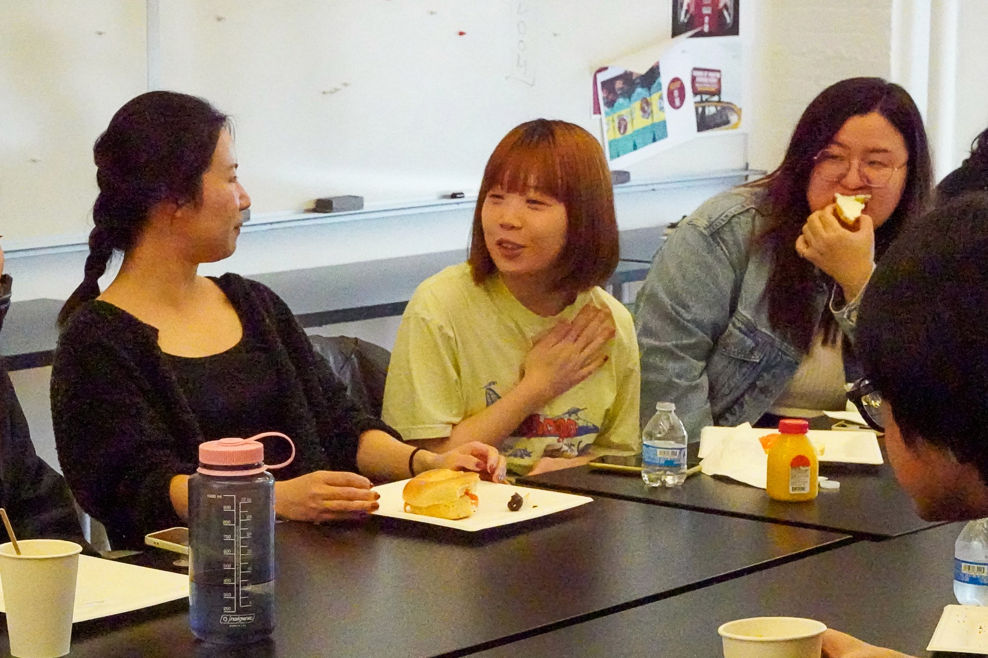 A photo of a group of people sitting at a conference table in an office room.