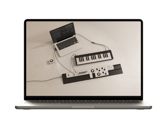 Laptop displaying a creative workspace setup with music production equipment and a digital interface.