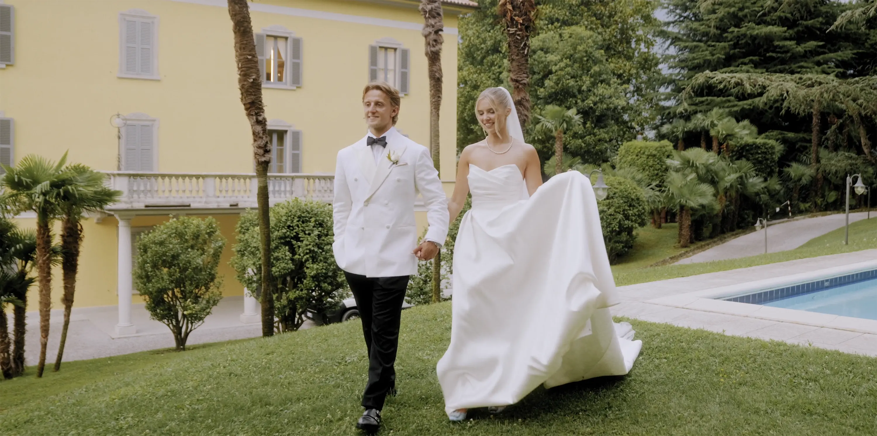 Cinematic wedding film of Rachel and George walking through the gardens of Villa Aura del Lago on Lake Como Italy