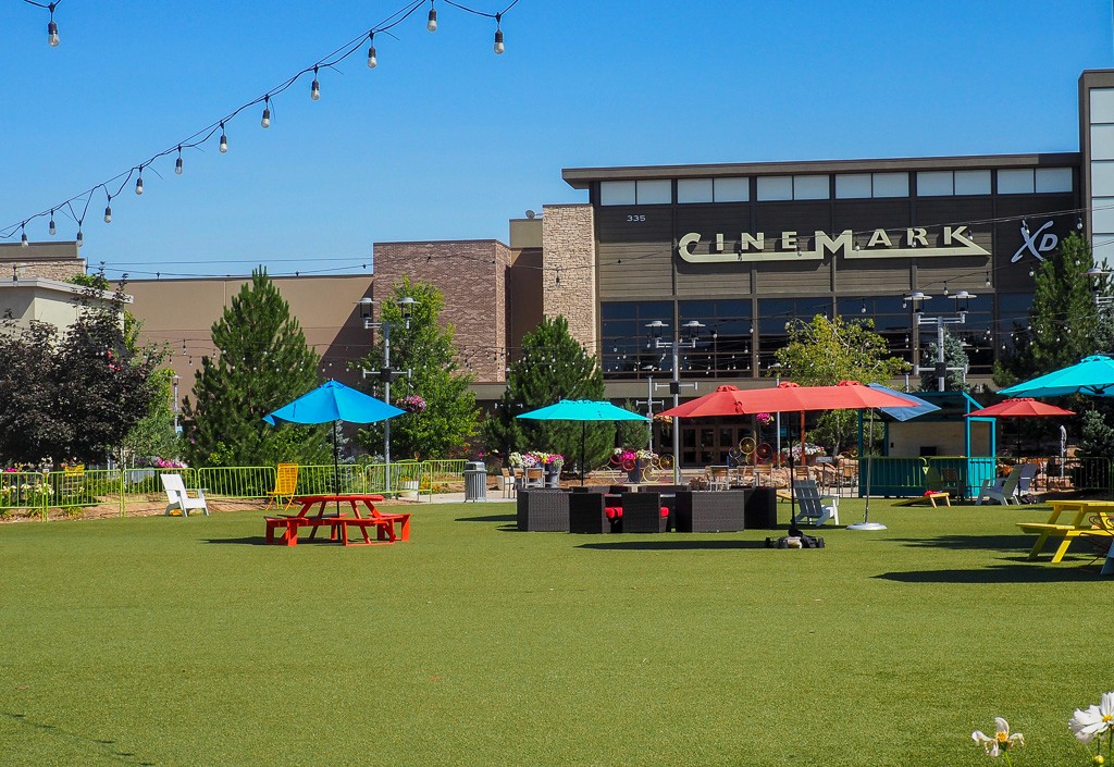 An outdoor community event under a canopy tent on a grassy field at the Foothilil Mall.