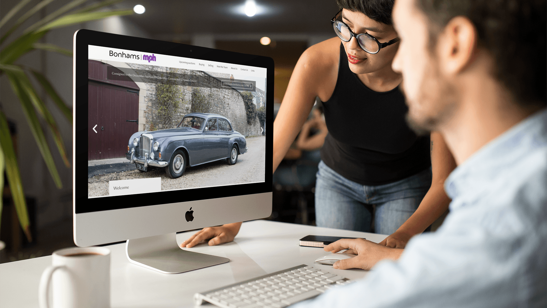 Two people looking through the Bonhams website