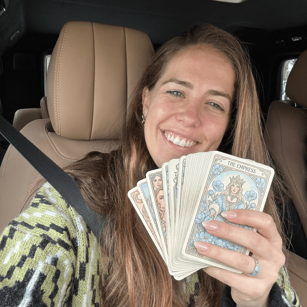 Minimal sculptural cake with vertical ridges, topped with glossy black glaze dripping over a white surface, displayed on a marble pedestal.