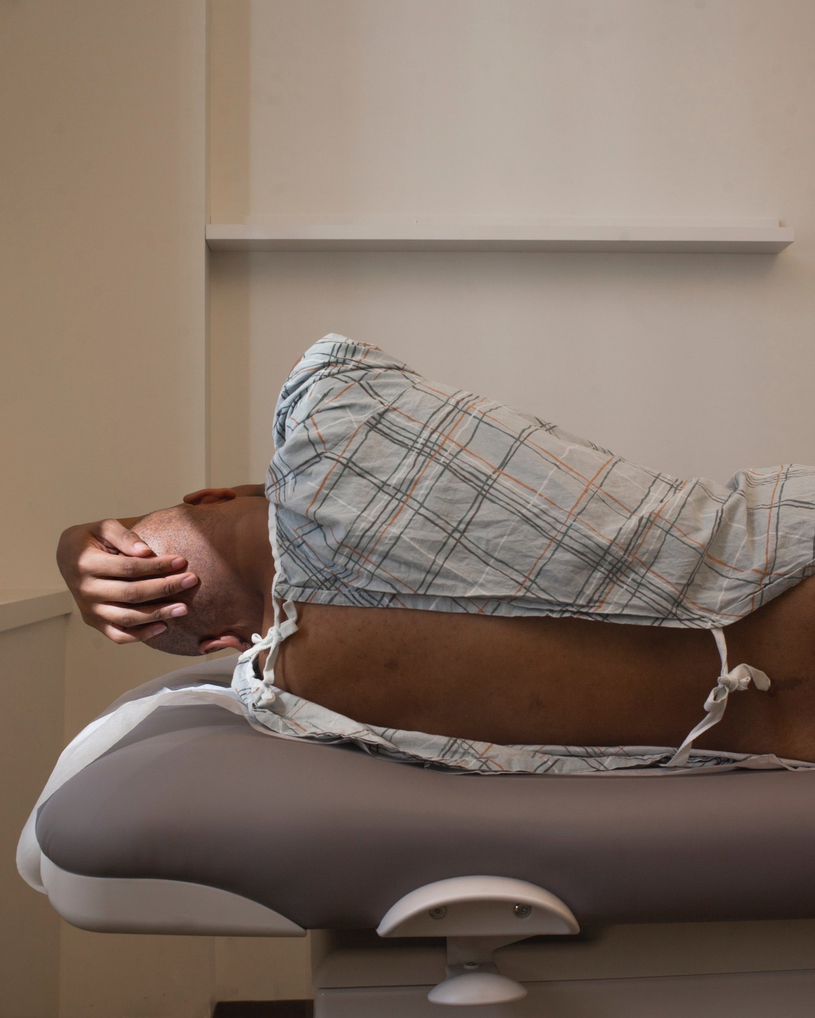 A small, dark flask is nestled among twigs and leaves on a forest floor, with a muted, mysterious ambiance.