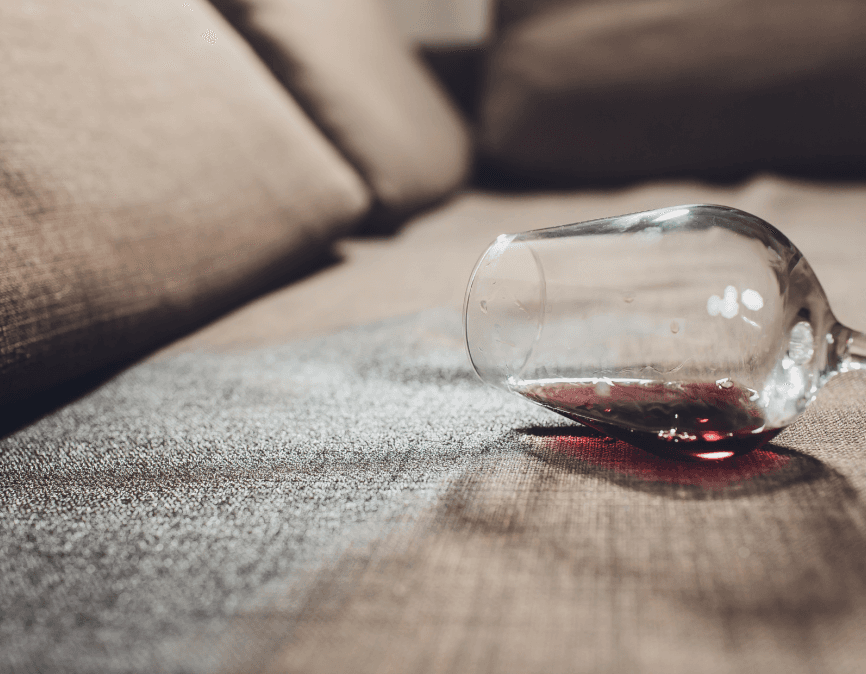 A person in protective suit cleans a carpet.