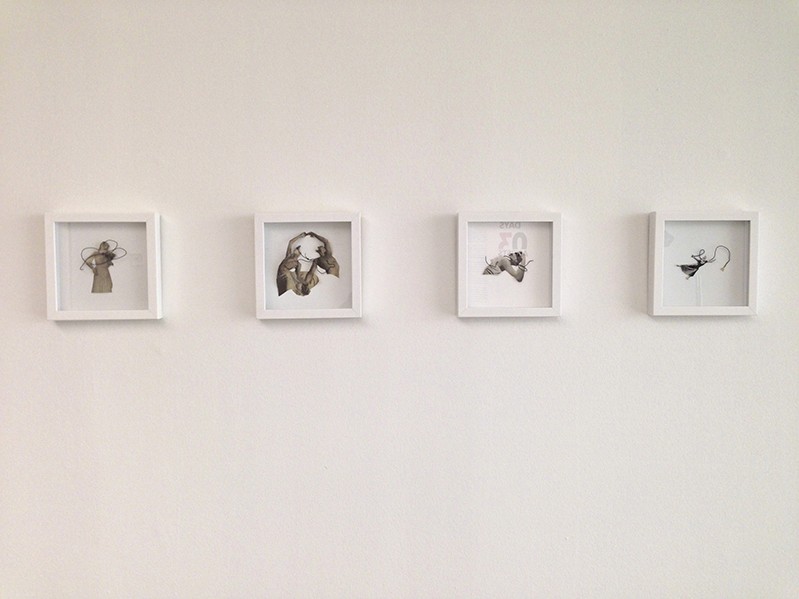 four illustrations framed in a white wooden frame are installed on a wall