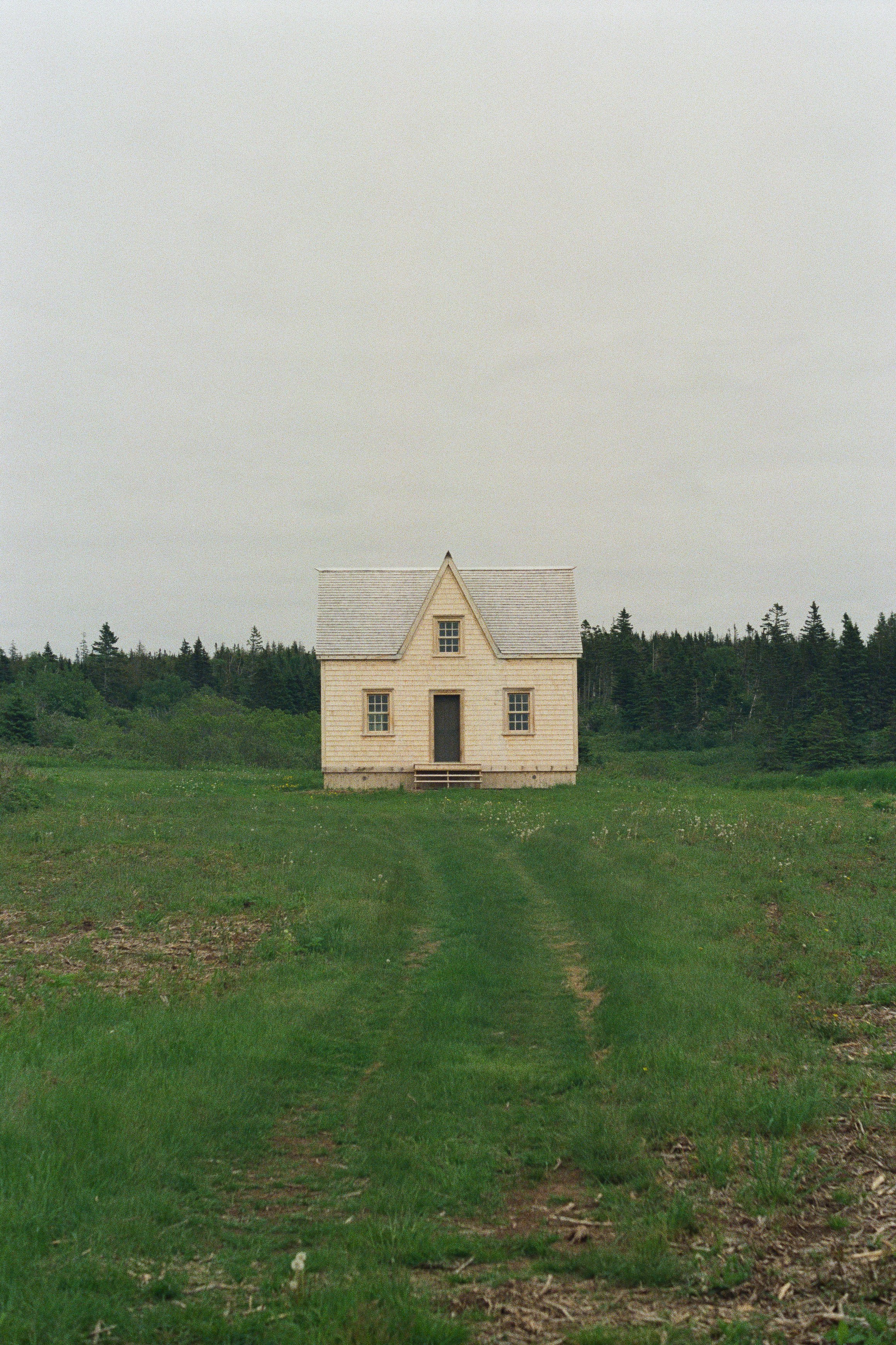 brown concrete house on green grass field