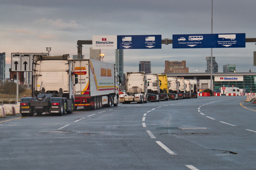 Freight trucks lined up at a shipping port checkpoint