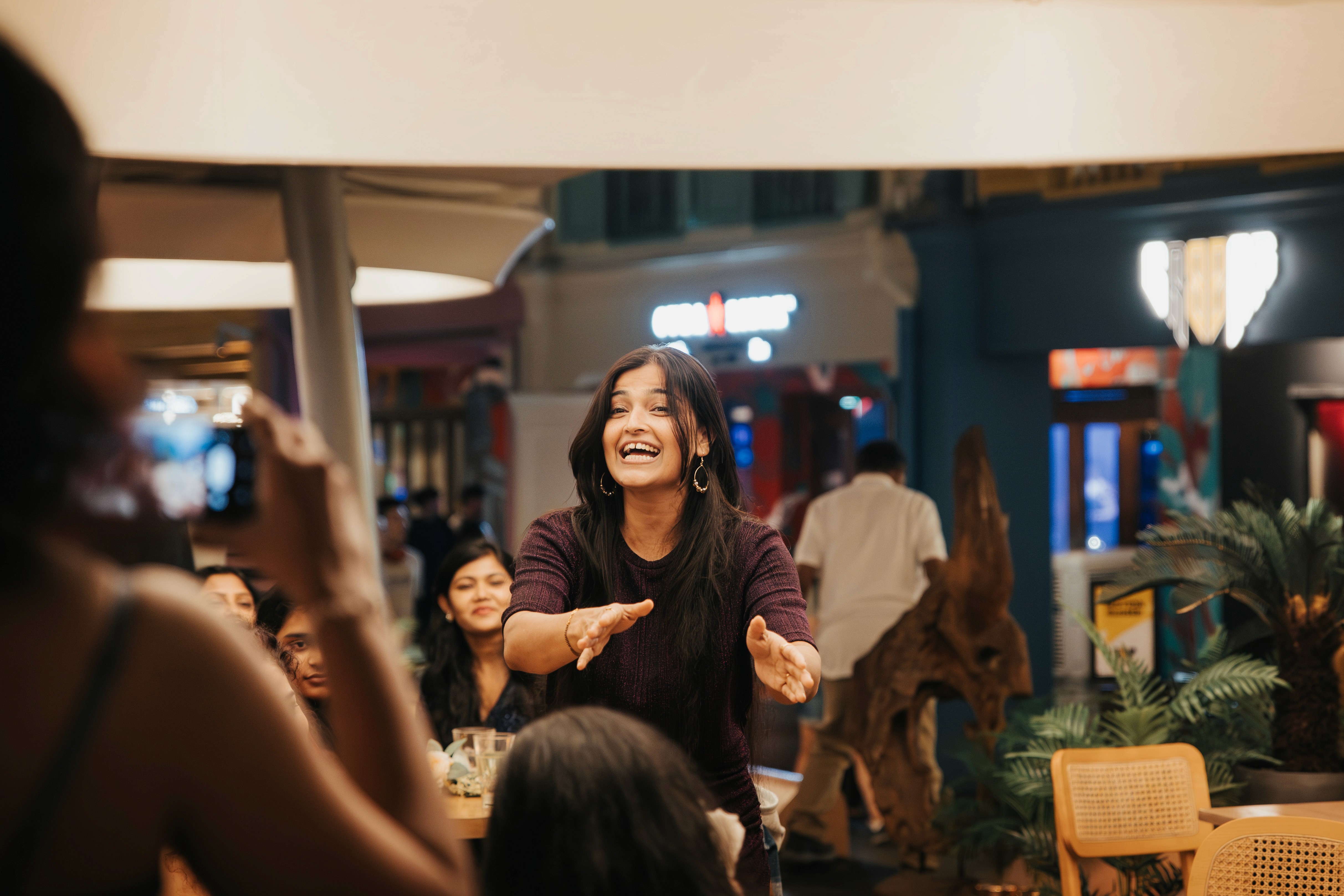 Authentic moment of laughter and celebration during a marriage anniversary event in Singapore.