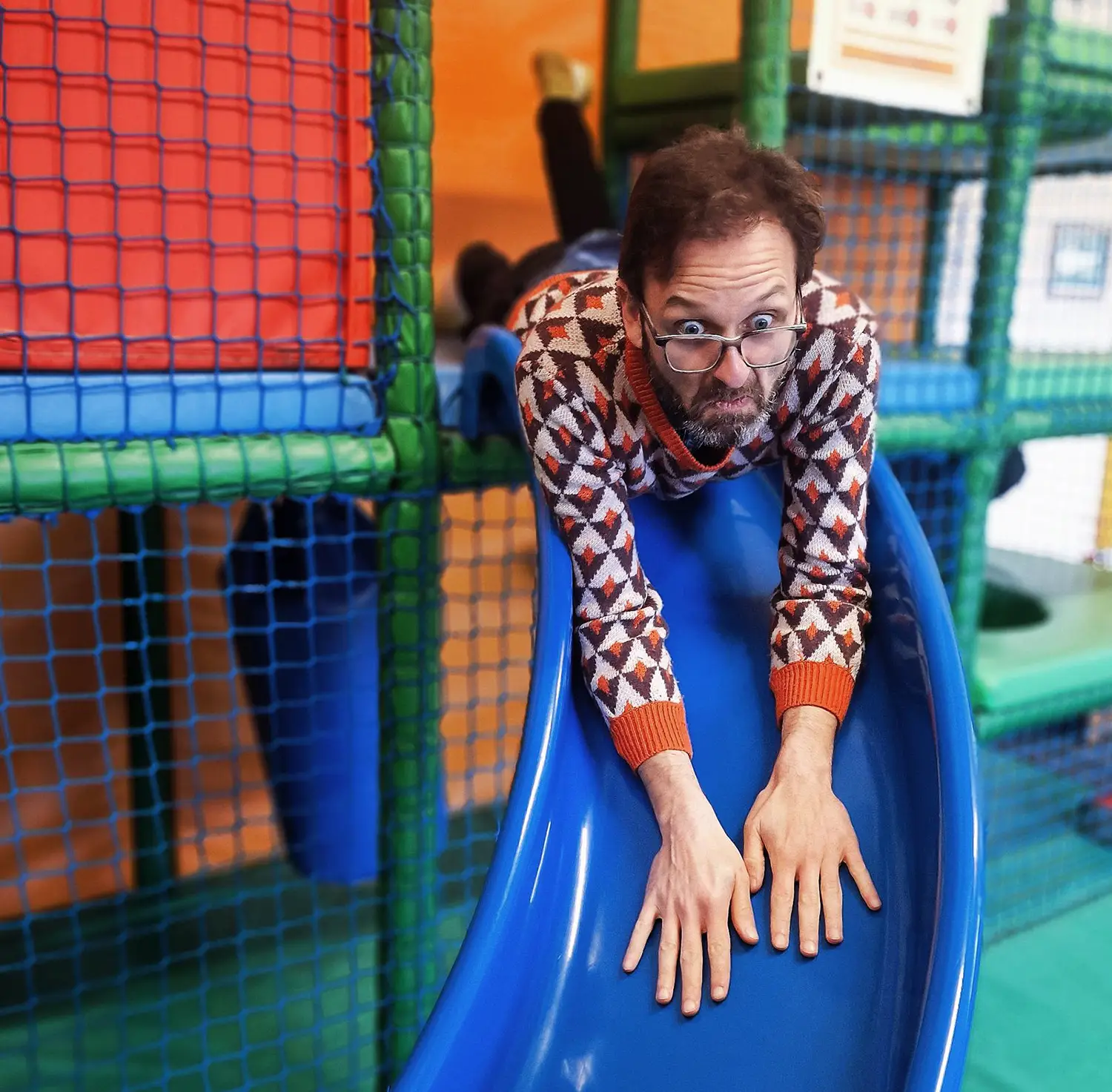 Froomies community member sliding down soft play slide during barn transformation week
