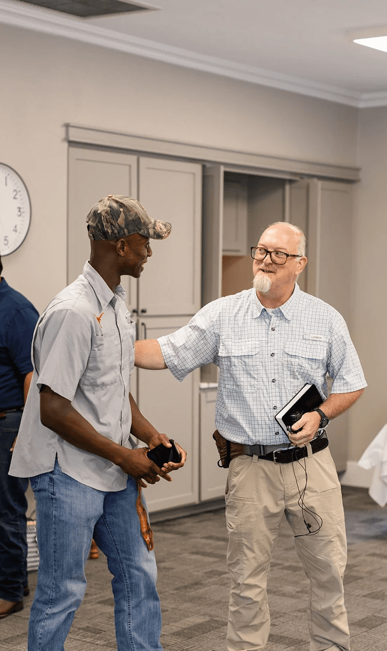brothers greeting each other at the church in College Station