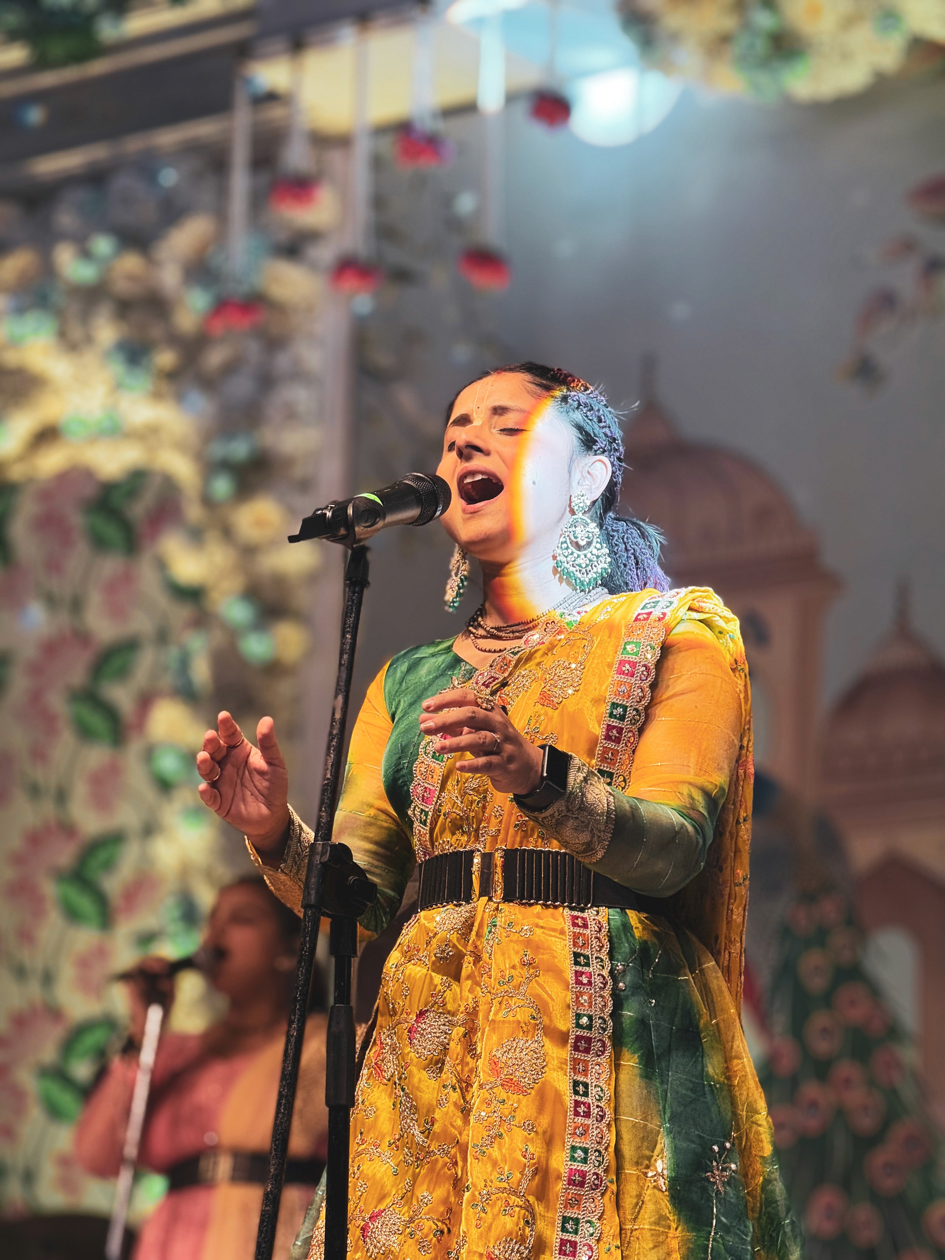 Performer under spotlight on dark stage